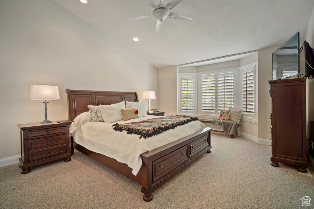 Bedroom featuring recessed lighting, light carpet, lofted ceiling, and baseboards