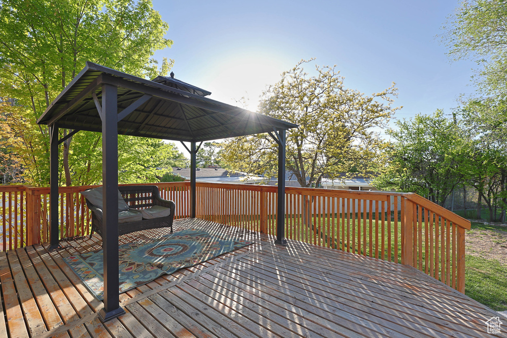 Wooden deck featuring a gazebo