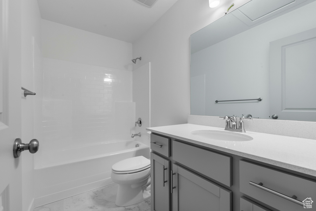 Full bathroom with vanity, visible vents, marble finish floor, toilet, and shower / bath combination
