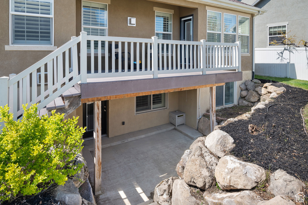 Exterior space with a patio area and stucco siding