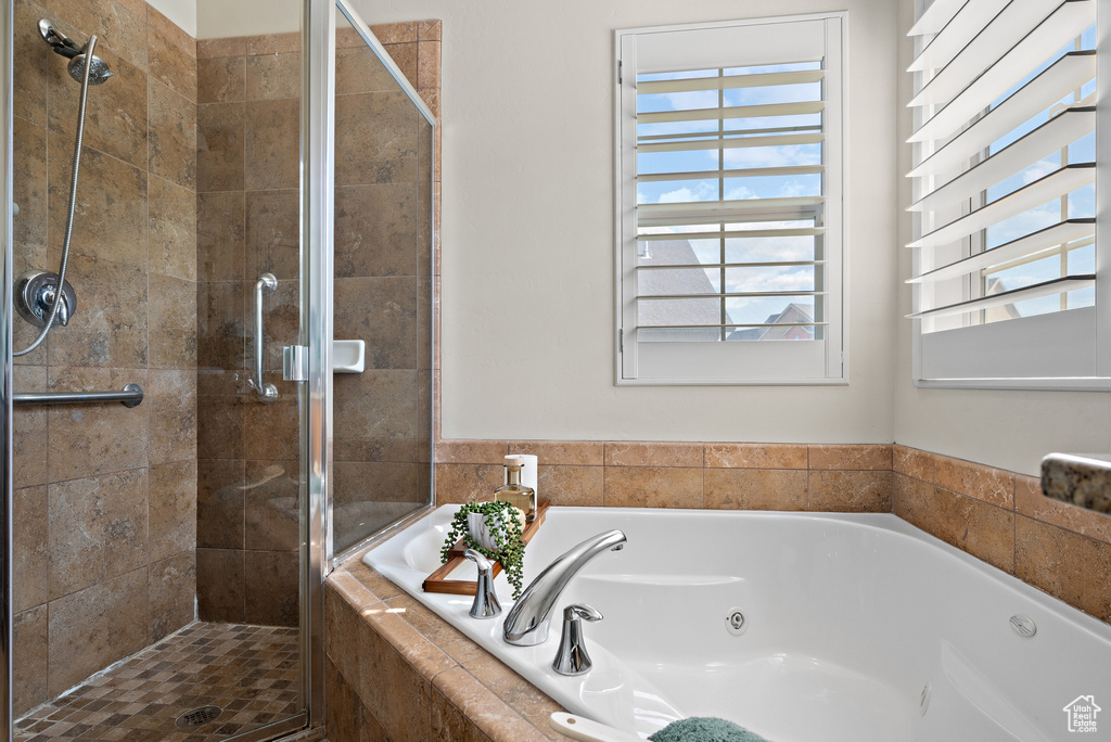 Full bath with a shower stall and a tub with jets