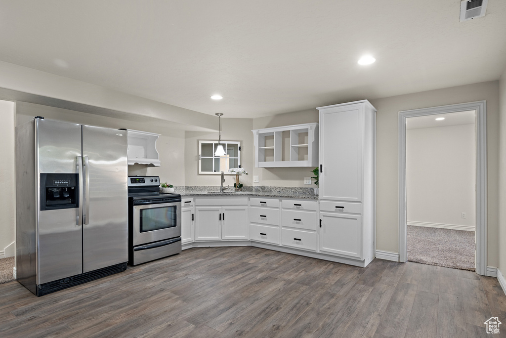 Kitchen with a sink, dark wood finished floors, stainless steel appliances, white cabinetry, and visible vents