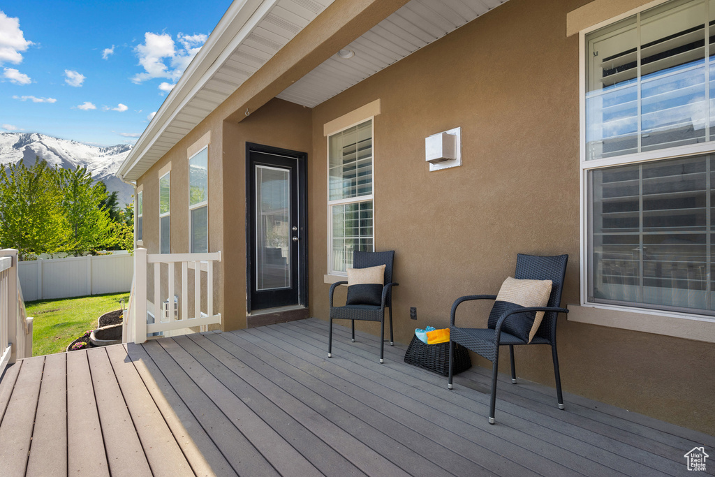 Deck featuring fence and a mountain view