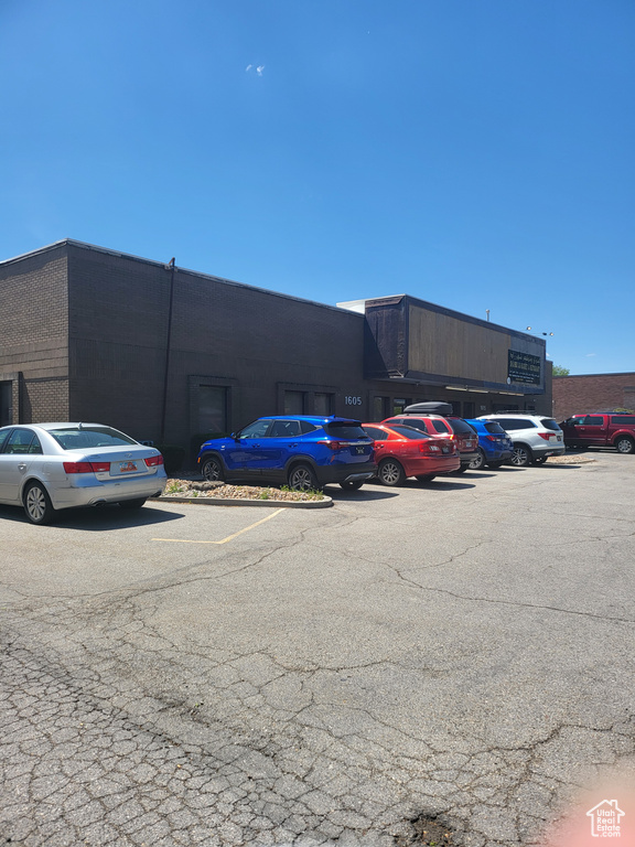 View of property featuring uncovered parking