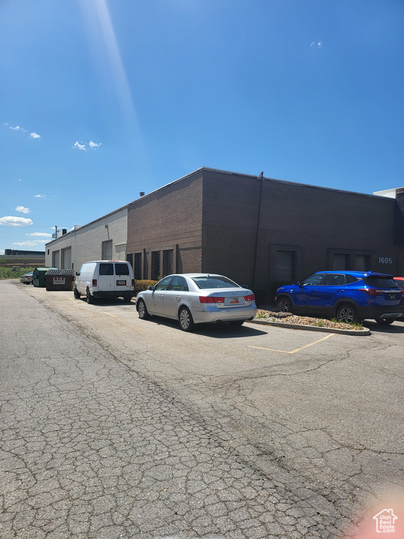 View of property featuring uncovered parking