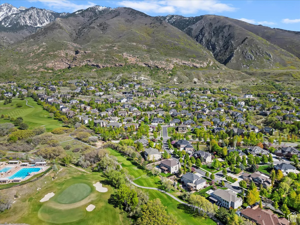 Drone / aerial view with a mountain view, golf course view, and a residential view