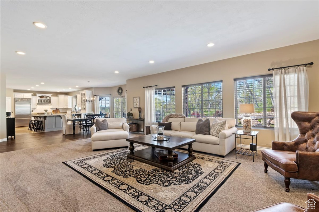 Living area with recessed lighting, baseboards, and light colored carpet