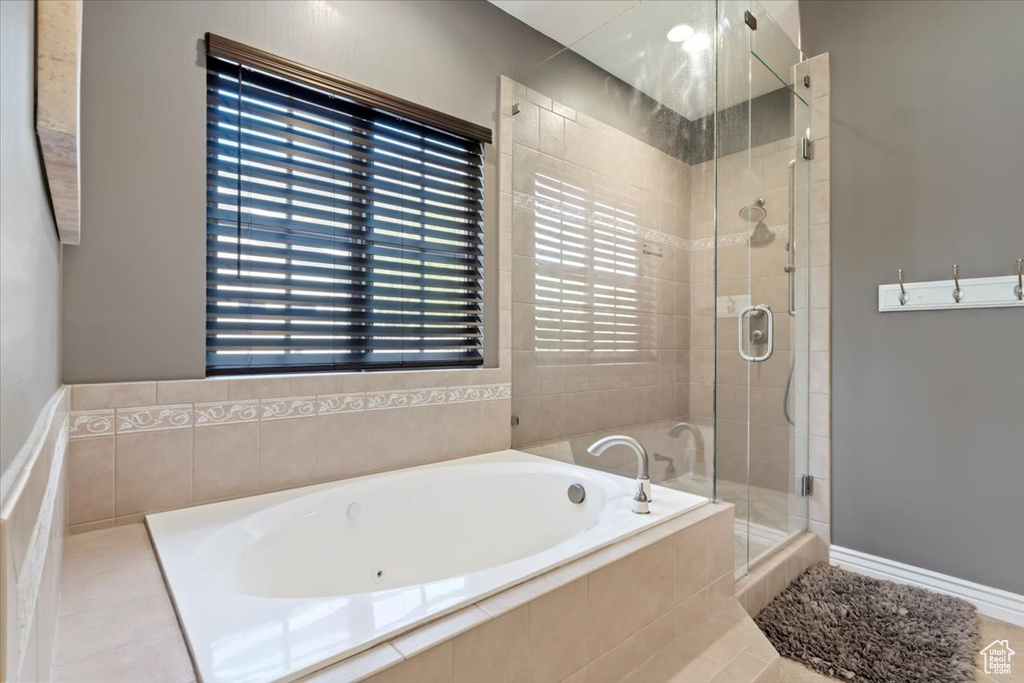 Bathroom featuring a bath and a stall shower
