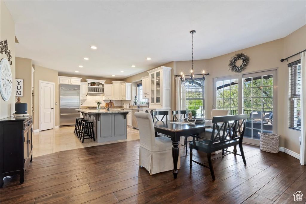 Dining space featuring recessed lighting, baseboards, dark wood-style flooring, and a chandelier