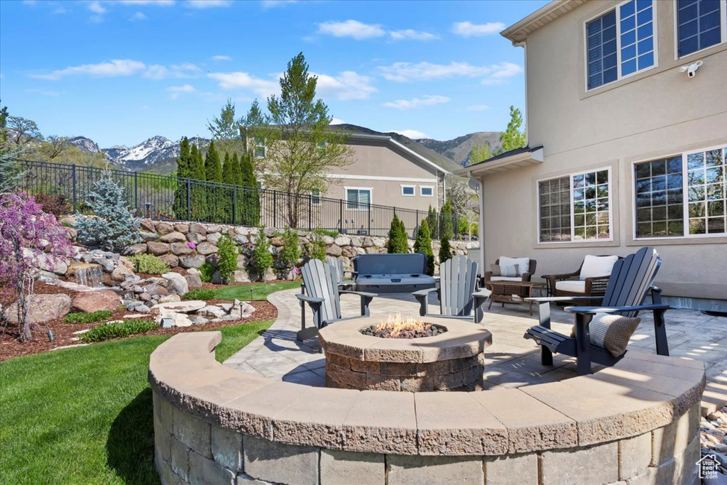 View of patio / terrace featuring a fire pit, a mountain view, and fence