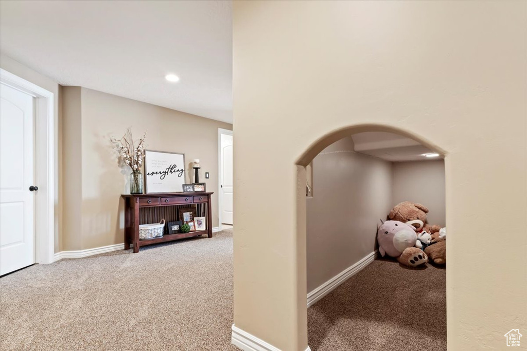 Hall with recessed lighting, carpet floors, baseboards, and arched walkways