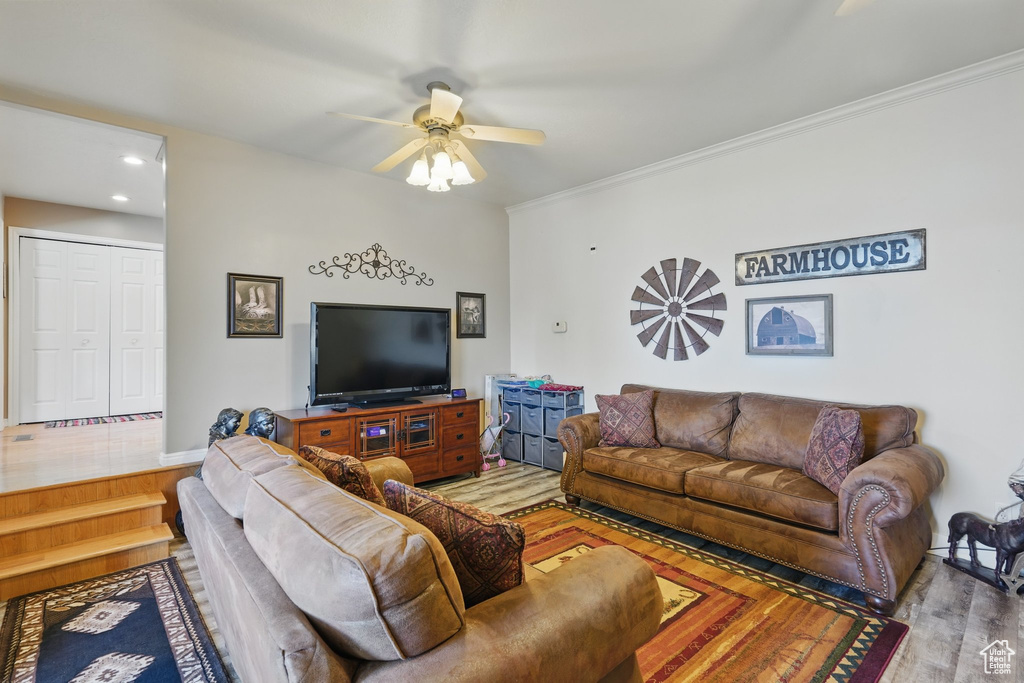 Living room featuring recessed lighting, ornamental molding, ceiling fan, and wood finished floors