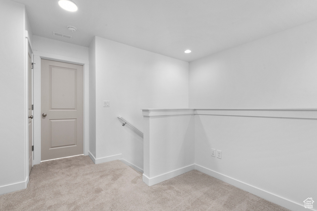 Walk in closet featuring visible vents and light colored carpet