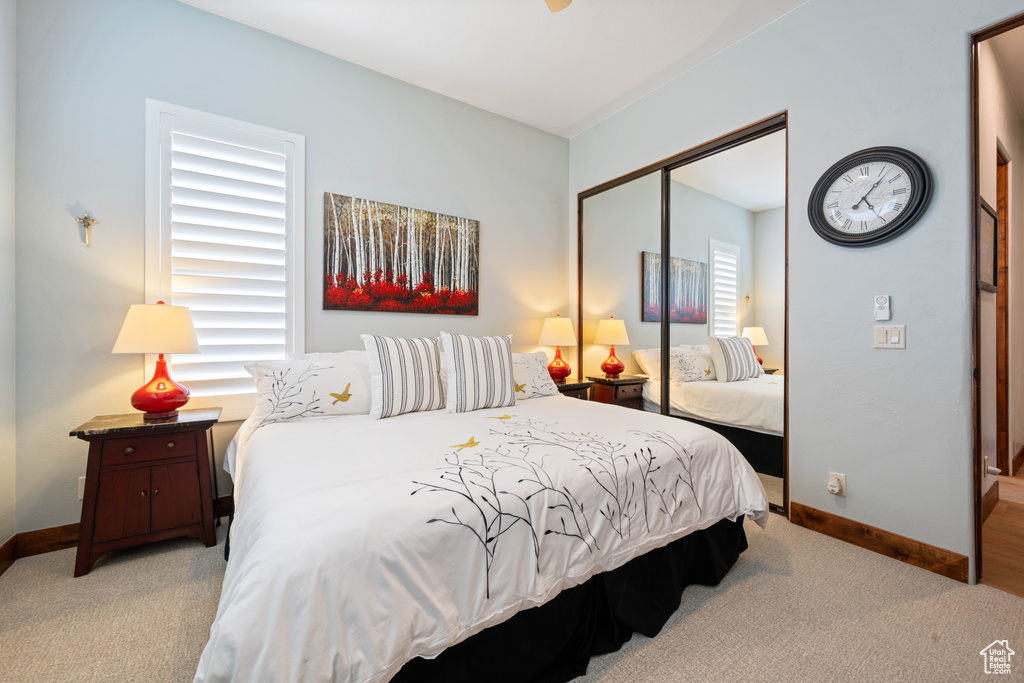 Carpeted bedroom featuring baseboards and a closet