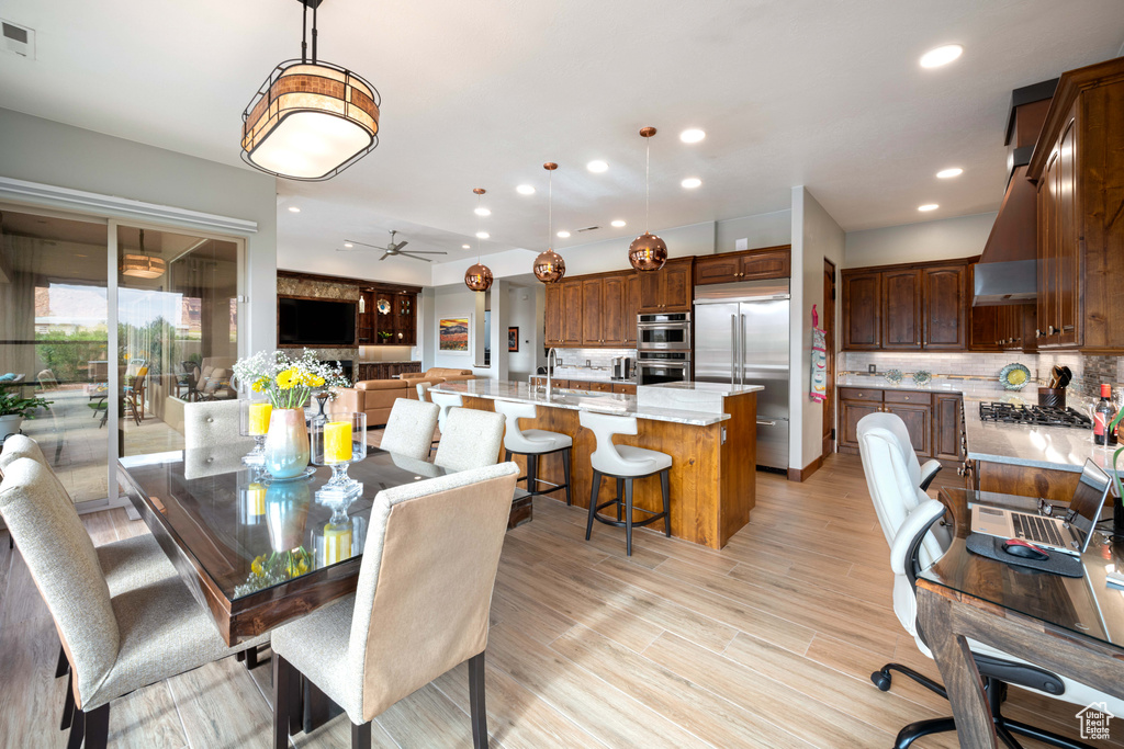 Dining room featuring recessed lighting, light wood finished floors, ceiling fan, and visible vents