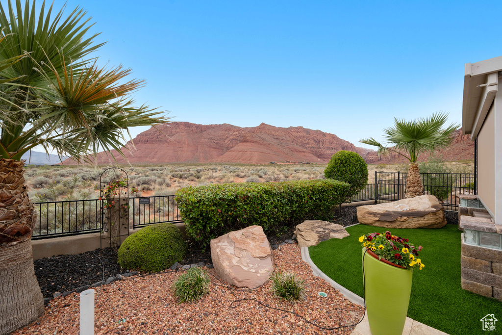 View of yard with a fenced backyard and a mountain view