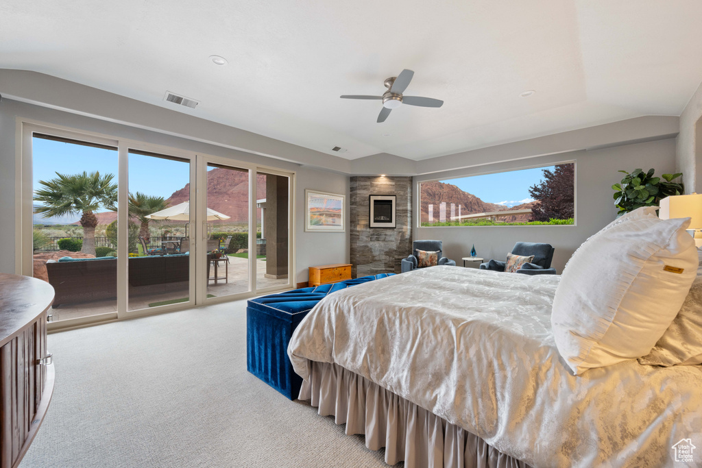 Bedroom featuring ceiling fan, visible vents, lofted ceiling, access to outside, and light carpet