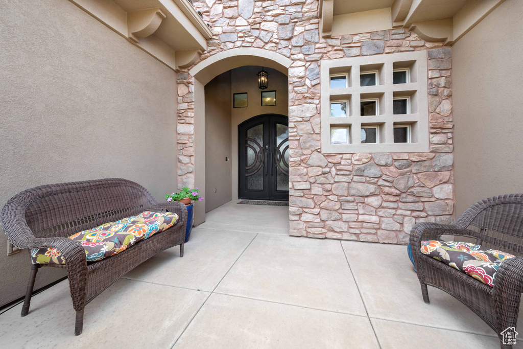 View of exterior entry featuring stucco siding and stone siding