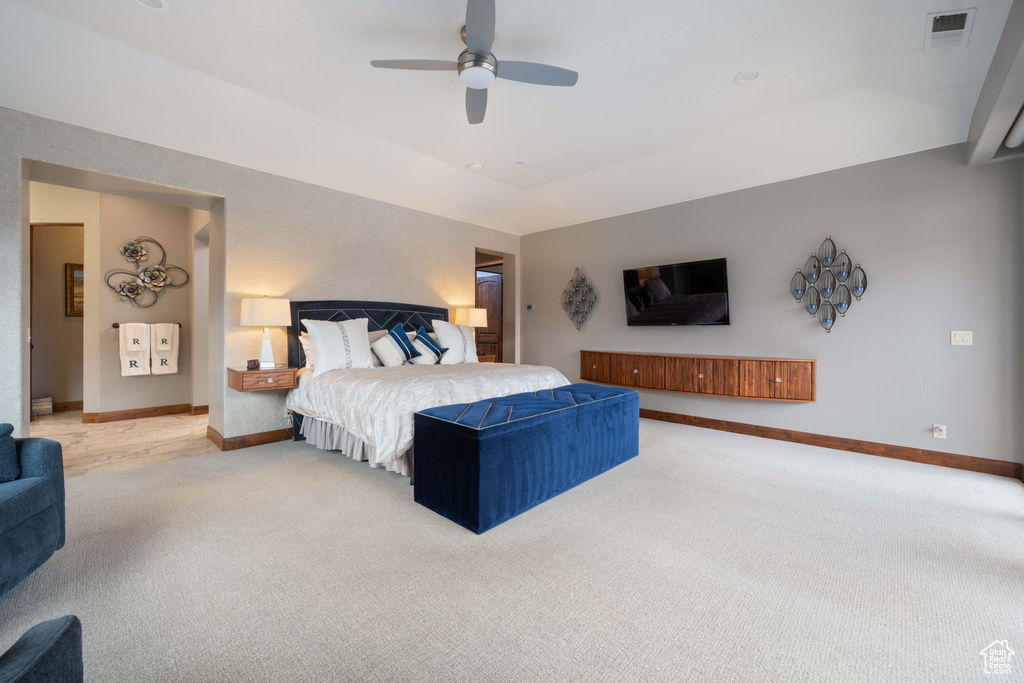 Bedroom featuring baseboards, light carpet, a ceiling fan, and visible vents