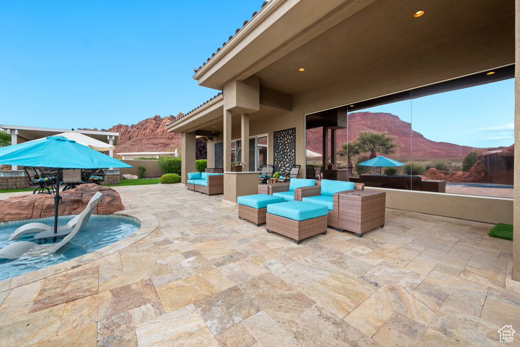 View of patio / terrace with fence, outdoor lounge area, and a mountain view