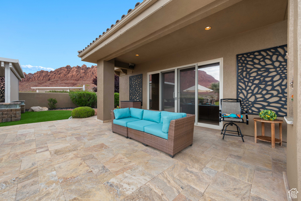View of patio with a fenced backyard, outdoor lounge area, and a mountain view