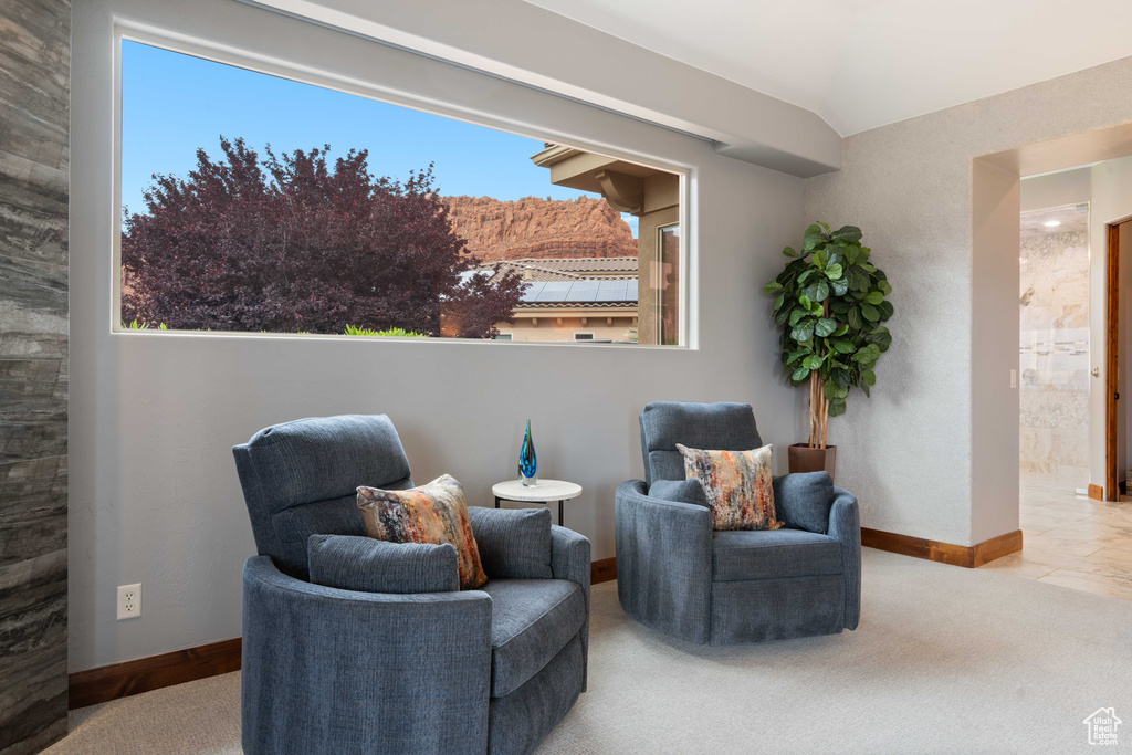 Sitting room with baseboards, carpet, and vaulted ceiling