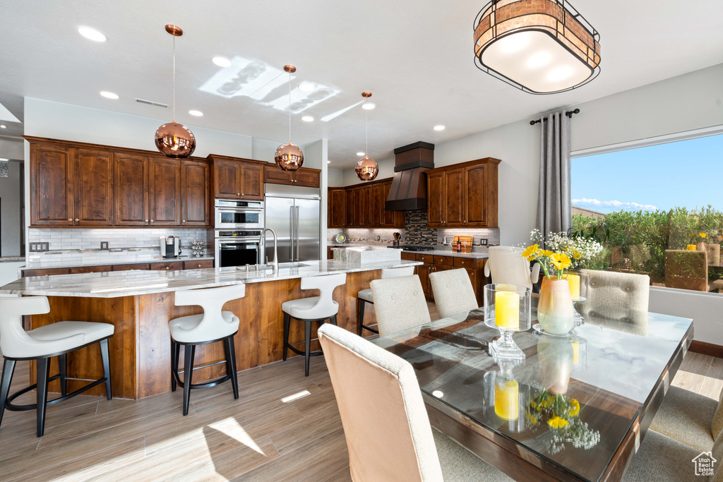 Dining room with recessed lighting and light wood-style floors