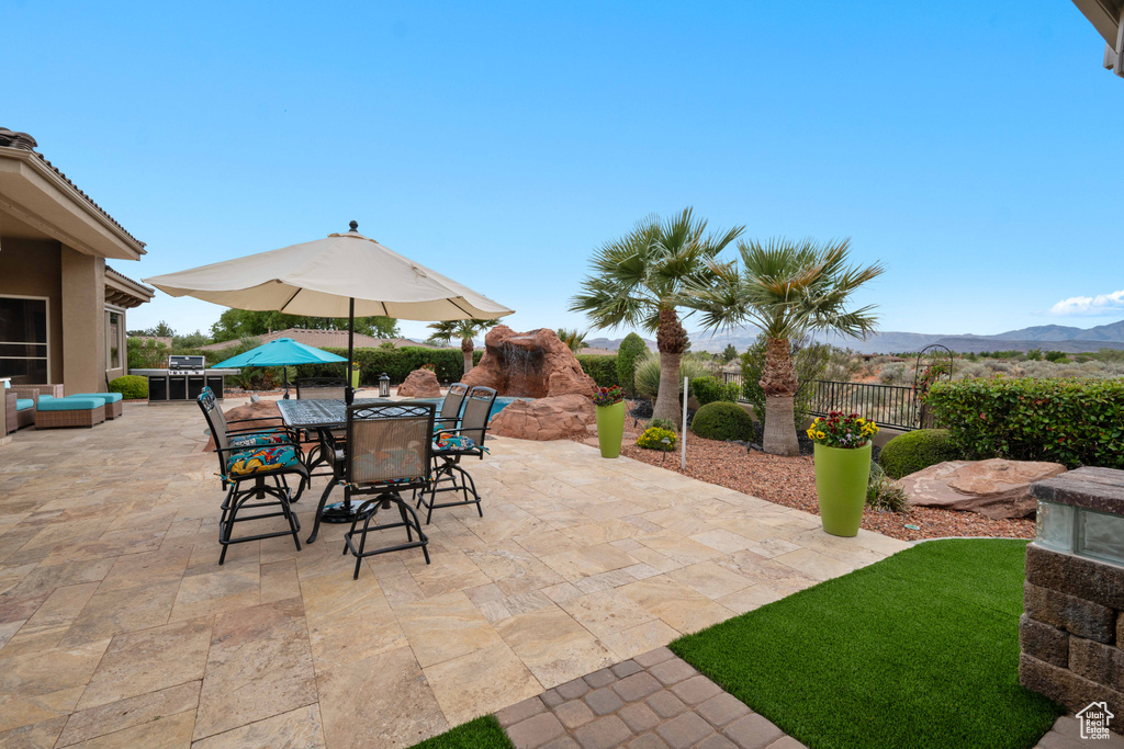 View of patio / terrace with fence, a mountain view, and outdoor dining space