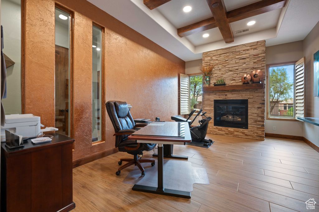 Office with wood finished floors, coffered ceiling, plenty of natural light, and beam ceiling