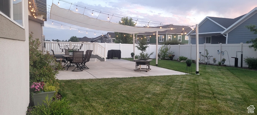 Fenced backyard featuring a patio and an outdoor fire pit