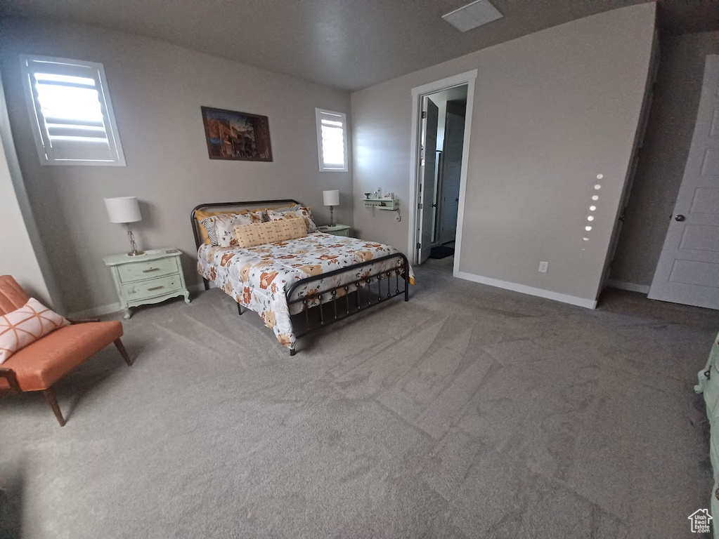 Carpeted bedroom featuring baseboards