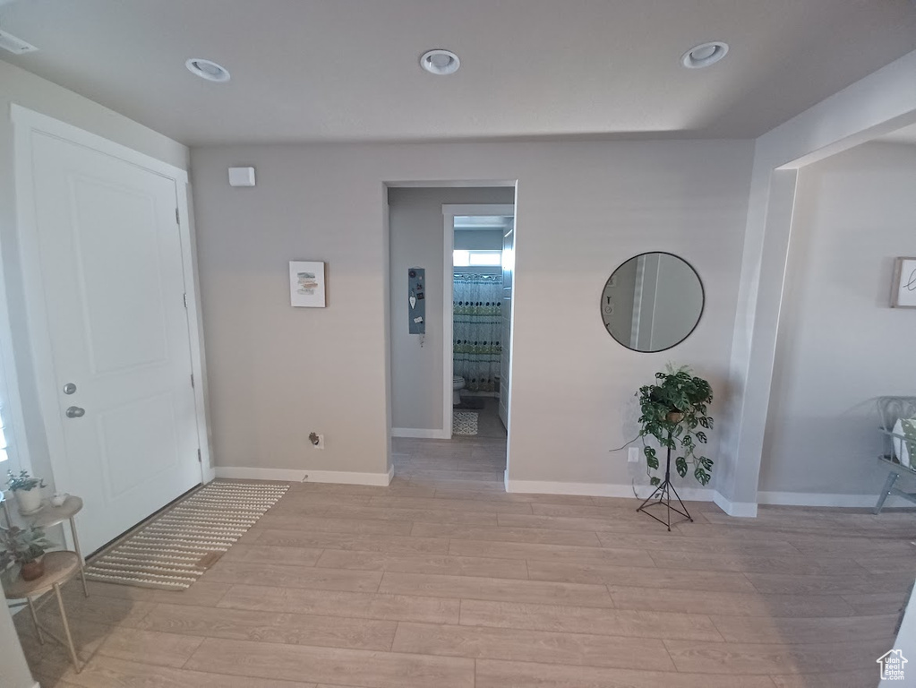 Foyer entrance with light wood-style flooring, baseboards, and recessed lighting