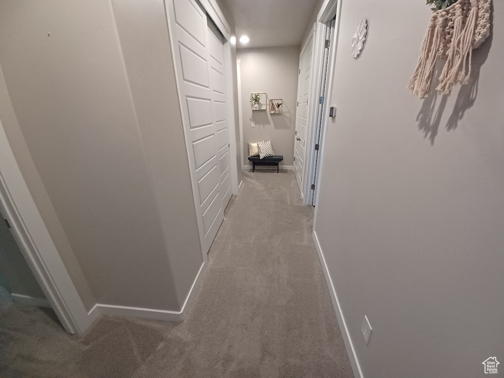 Corridor featuring carpet, baseboards, and recessed lighting