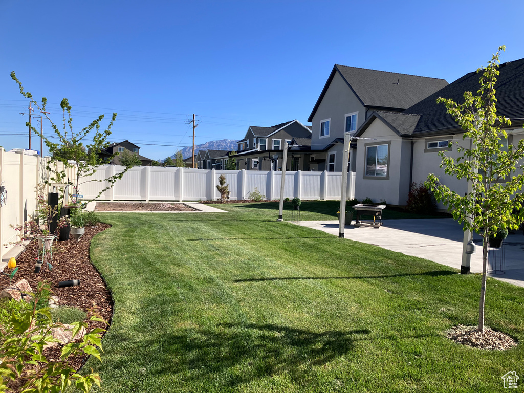 View of yard with a patio, a residential view, and a fenced backyard