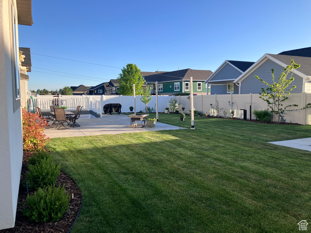 View of yard featuring a patio and a residential view