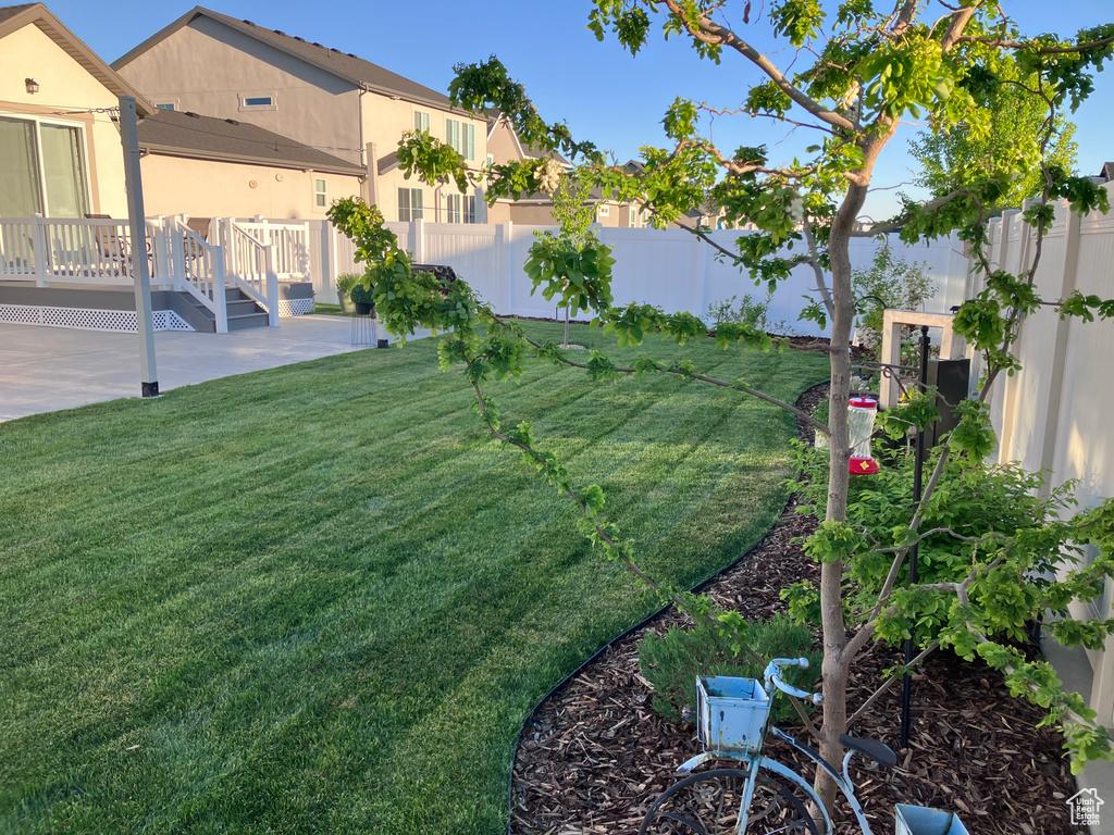 View of yard with a wooden deck