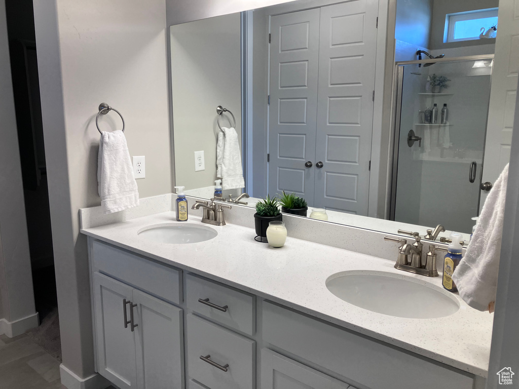 Bathroom with a stall shower and double vanity