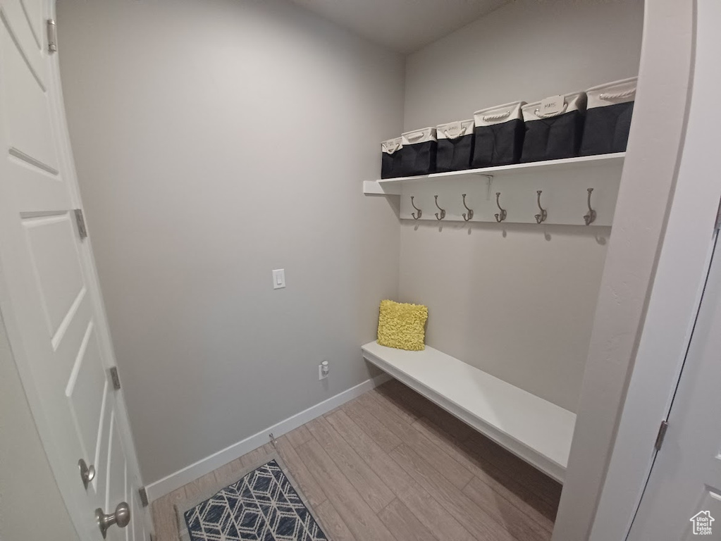 Mudroom featuring wood finished floors and baseboards