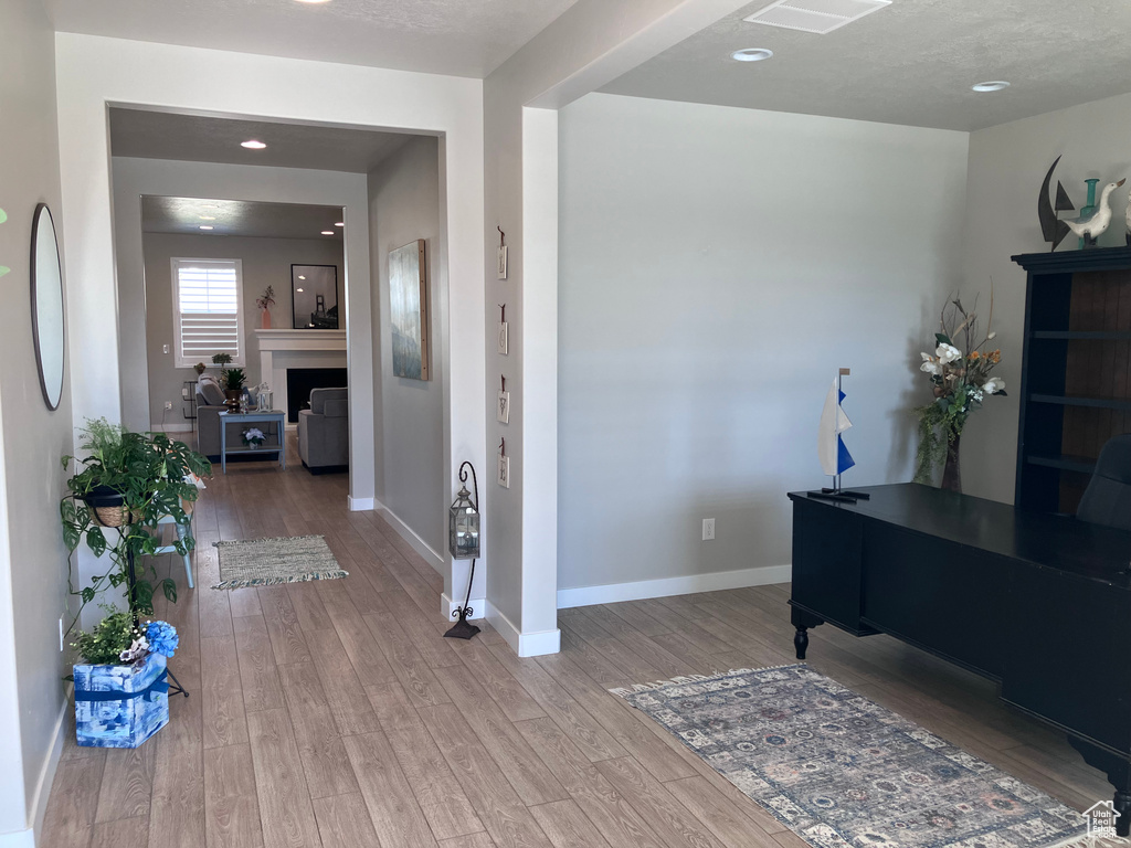Hall featuring wood finished floors and baseboards