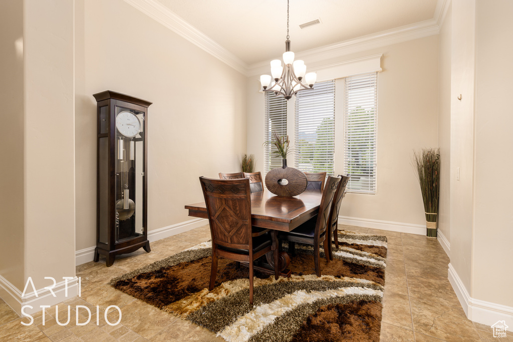 Dining area featuring crown molding, baseboards, and a chandelier