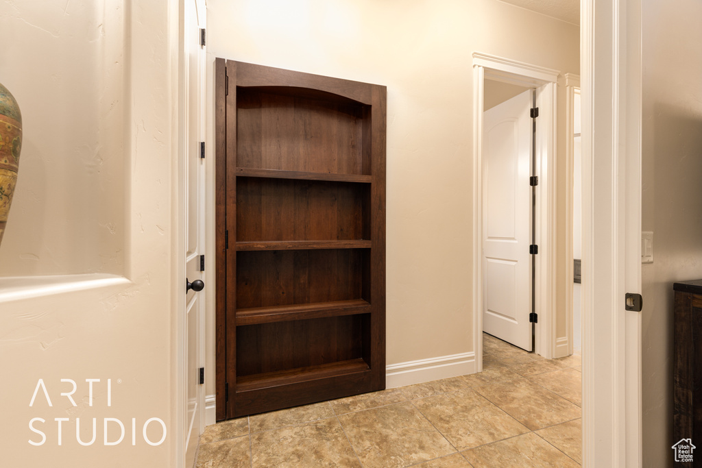 Interior space featuring baseboards and tile patterned flooring