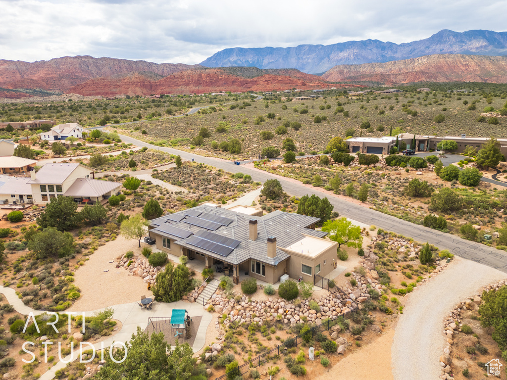 Drone / aerial view featuring a mountain view and view of desert
