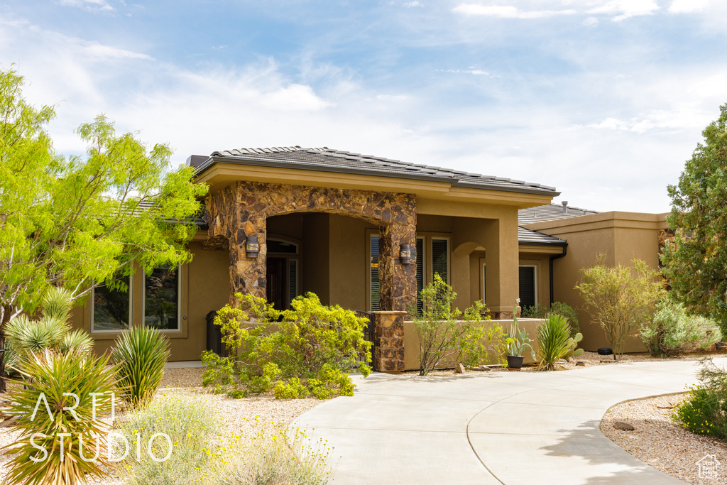 View of front of home with stucco siding and stone siding