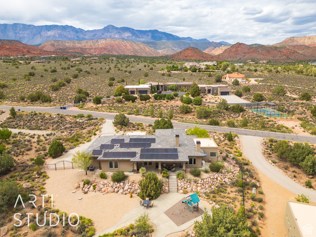 Drone / aerial view featuring a mountain view and view of desert