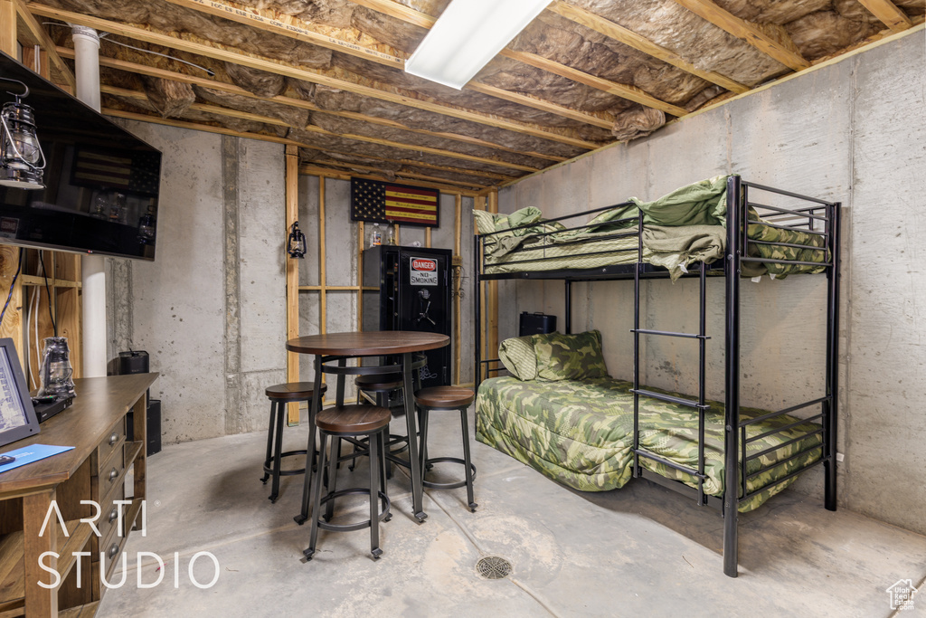 Bedroom featuring unfinished concrete flooring