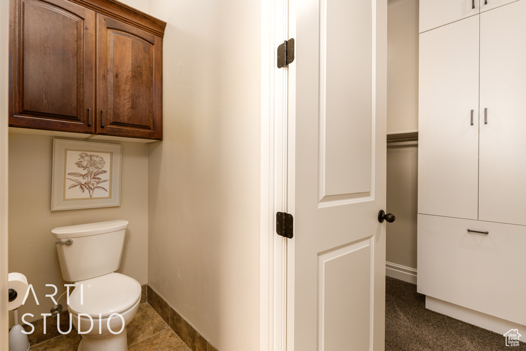 Bathroom featuring baseboards and toilet