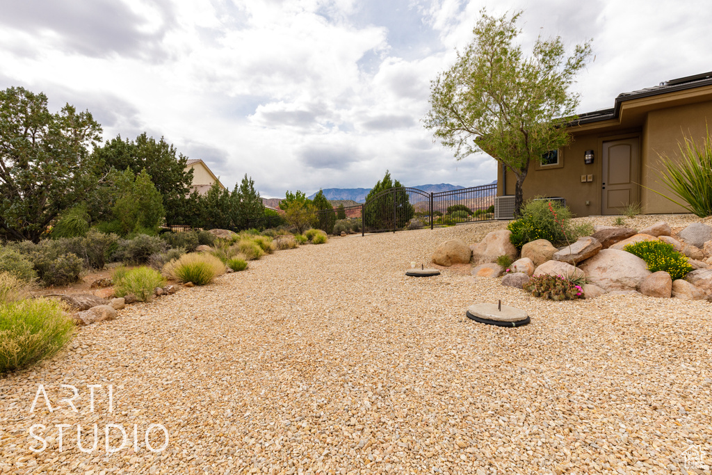 View of yard featuring fence and a mountain view