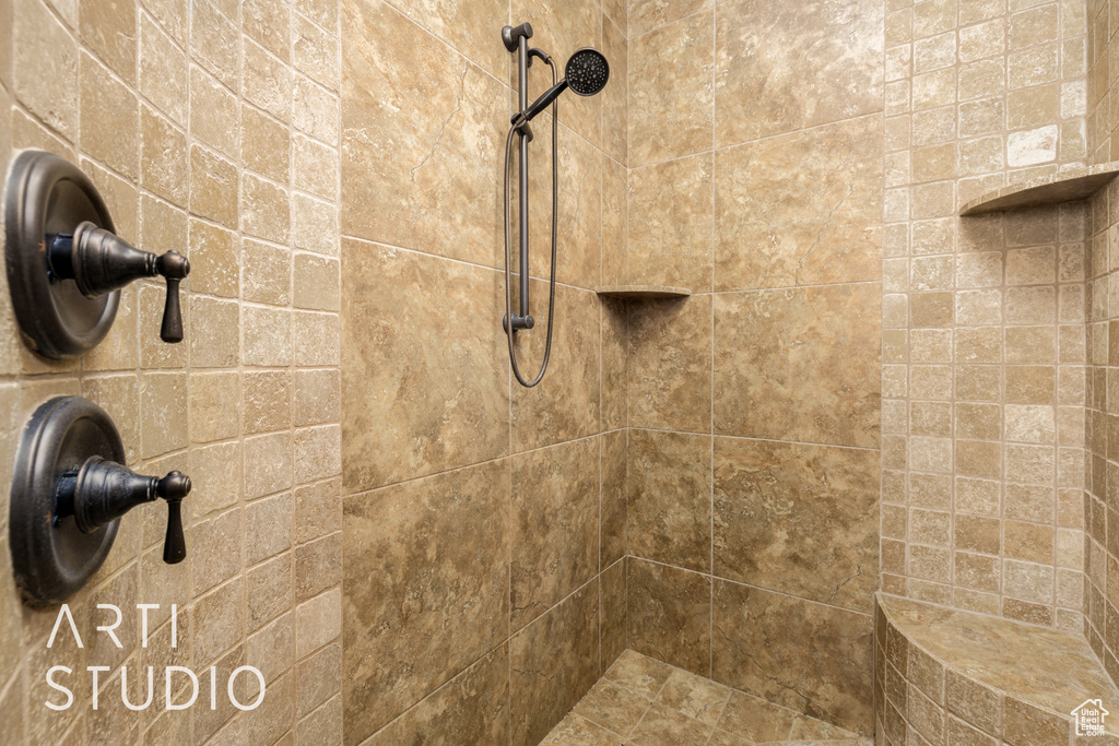 Room details featuring a tile shower