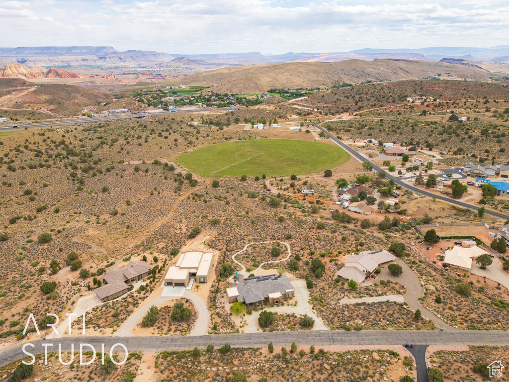 Drone / aerial view featuring a mountain view, view of desert, and a rural view