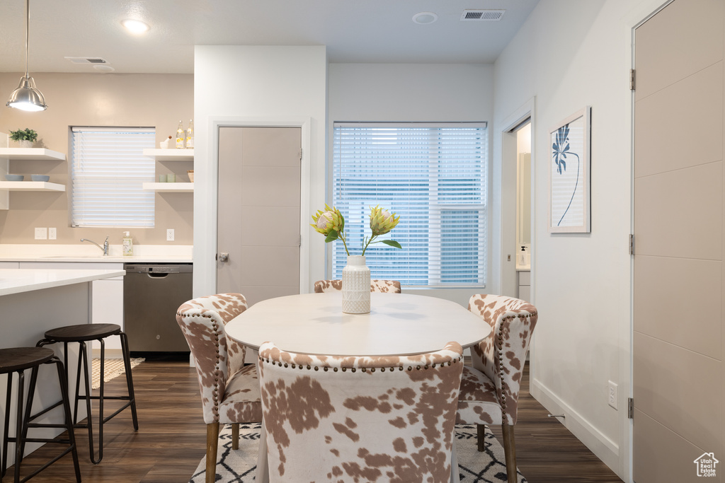 Dining area with baseboards, visible vents, and dark wood-type flooring